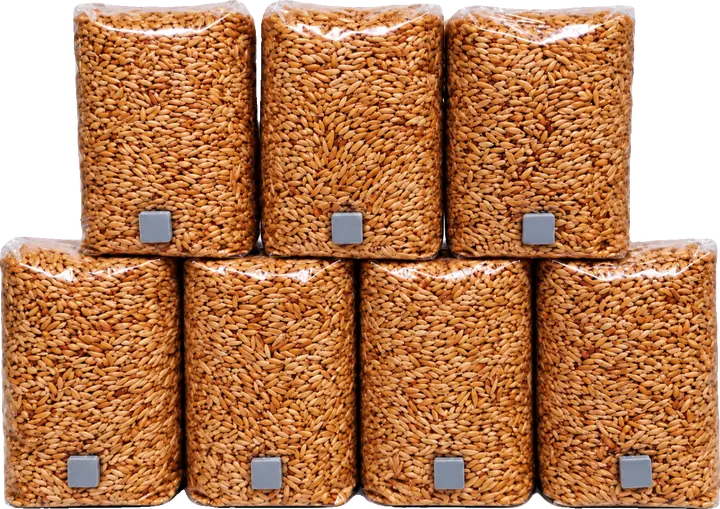 Seven bags of sterilised grain stacked in a pyramid, each with a grey injection port